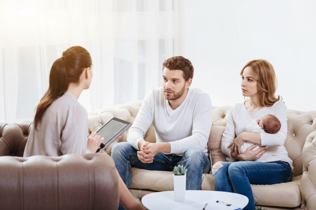 Couple attending a counseling session for emotional support during postpartum couple therapy