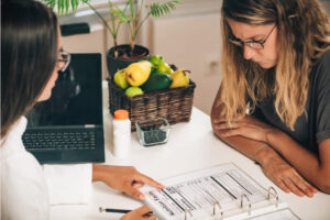 Nutritionist in Edmonton spring integrative reviewing the diet plan for patient who is seeking fertility.