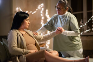 Therapist performing Edmonton prenatal massage on pregnant woman to ease discomfort.